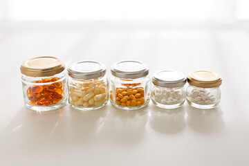 Health concept. Glass bottles of vitamin in morning light.