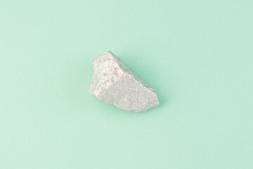 Rock on teal background top view