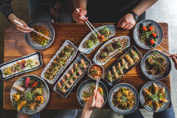 flatlay of people enjoying Asian food