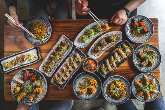 top town of people enjoying Asian food - Powered by Adobe