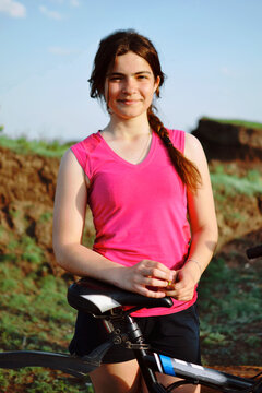 A beautiful girl is preparing for a bike ride.