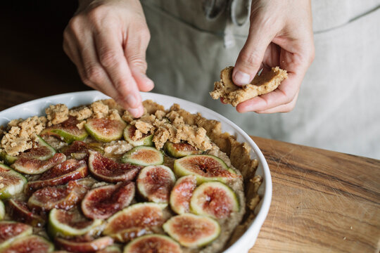 Woman Decorating Homemade Figs Tart