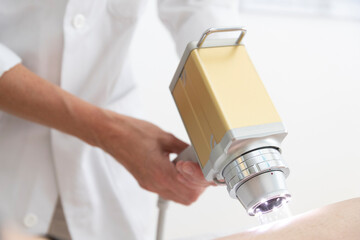 a dermatologist performs a skin exam