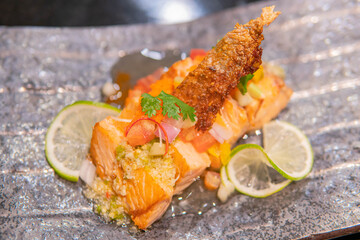 Fried salmon fillet with lemon and basil.