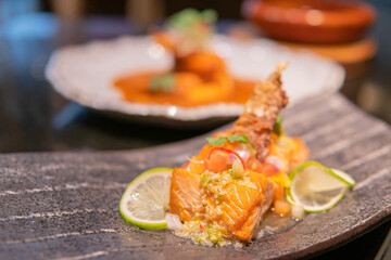 Fried salmon fillet with lemon and basil.