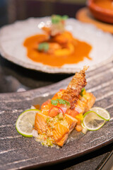 Fried salmon fillet with lemon and basil.