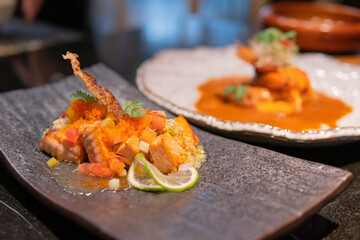 Fried salmon fillet with lemon and basil.