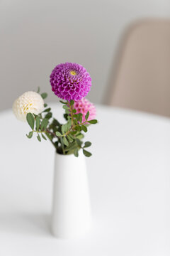 flowers in a vase, placed on a white table