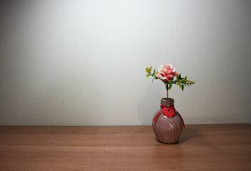 Pink rose flowers in vintage vase on wooden table, floor, gray cement wall Stylish stock image format for banner templates, text artwork, quotes, fonts, festivals