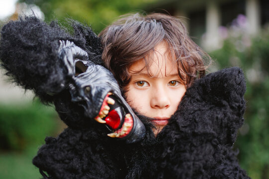 close-up of beautiful boy wearing a gorilla costume outside