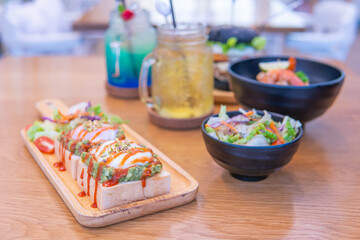 Dinner in cafe with eggs benedict, toast with avocado, pasta with shrimps and drinks