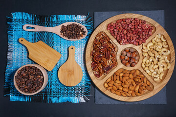 Nuts in a wooden plate. Pecans, almonds, cashews, peanuts, walnuts, pine nuts. flat lay