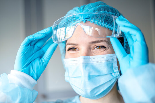 Happy Medical Surgical Doctor and Health Care, Portrait of Surgeon Doctor in PPE Equipment on Isolated Background. Medicine Female Doctors Wearing Face Mask and Cap for Patients Surgery Work.