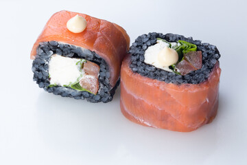 traditional Japanese cuisine. japanese sushi isolated on white background. maki sushi with salmon, tomato, soft cheese (Philadelphia). black sushi