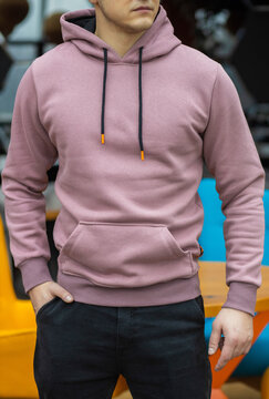 Handsome attractive European muscular man in purple hoodie