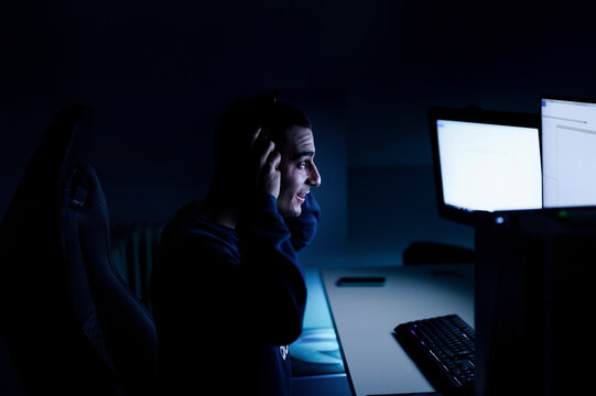 gamer boy looking at screen adjusts computer sound