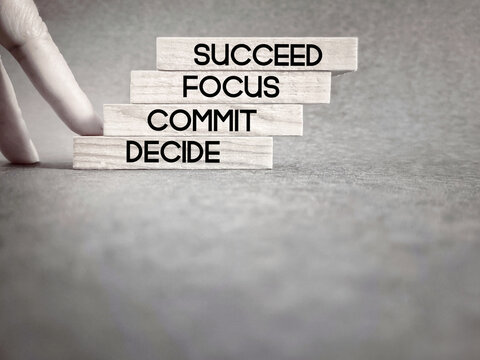 Motivational and Inspirational Concept - Decide commit focus succeed text on wooden blocks background. Stock photo.