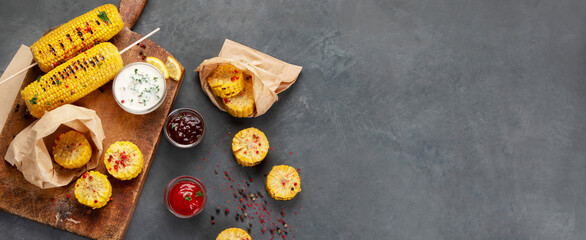 Grilled roasted sweet corn cobs with souces