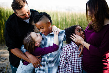 Family of Five Embracing at Park in Chula Vista