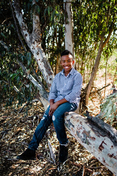 Young Boy Posing in Tree & Smiling for Camera at Park in Chula Vista
