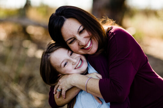 Mother & Daughter Embracing & Laughing at Park in Chula Vista