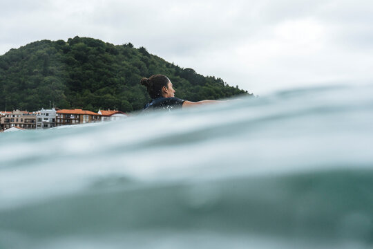 Surfer entering the water in Basque country, Spain, Bilbao