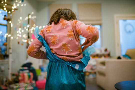 Little girl playing dress up with christmas gift princess outfit