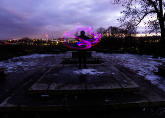 Silhouette Circus Model in Queens Park Bolton at Night in the Snow with Light Trails
