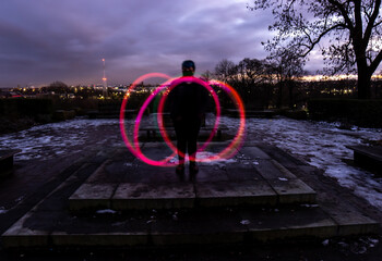 Silhouette Circus Model in Queens Park Bolton at Night in the Snow with Light Trails