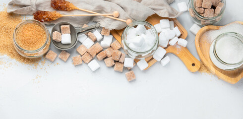 White and brown sugar on boards on linght background