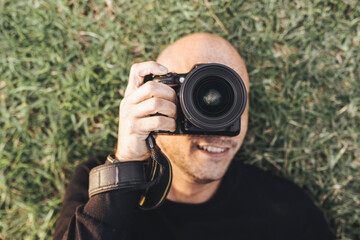 Aerial Shot Of A Photographer Lying On The Grass