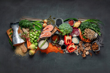 Obraz na płótnie Canvas Asian raw vegan food, grain, seeds and vegetables on dark background