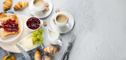 Delicious fresh breakfast served with drinks, croissants and fruits.