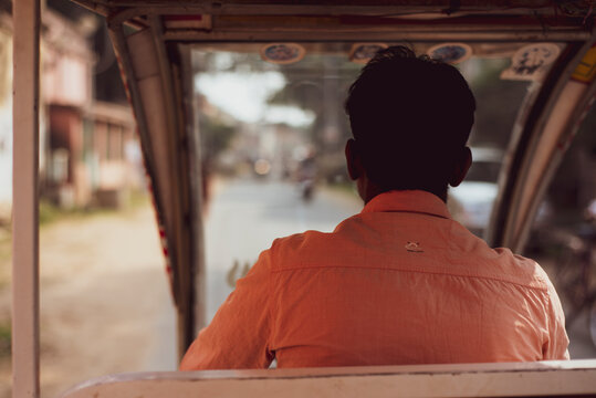 View from behind through autorickshaw taxi drivers window in India