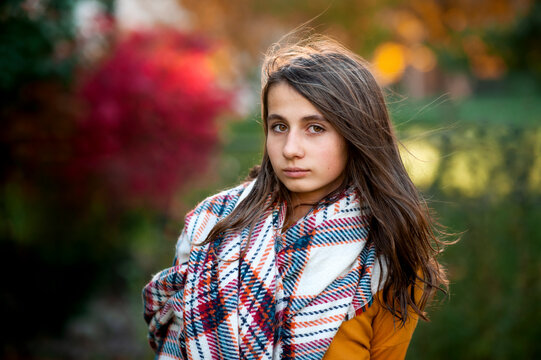 Portrait of teen girl 11-13 years old in warm clothes on fall day