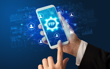 Female hand holding smartphone with FTP abbreviation, modern technology concept