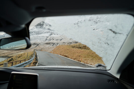 Looking through snow covered windshield of car in the Faroe Islands