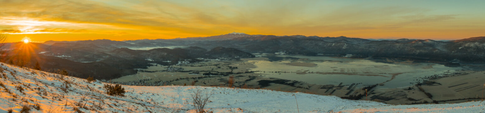 Early morning panorama of Cerknica lake viewed from above from Slivnica vantage point during sunrise. Beautiful sunrise photo of cerknica lake.