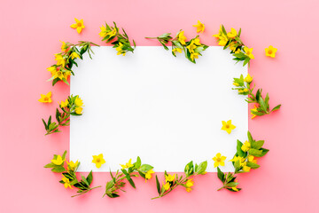 White paper mock up with yellow flowers, view from above