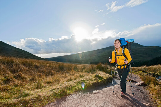 female hiker walking up towards Pen Y Fan in Wales
