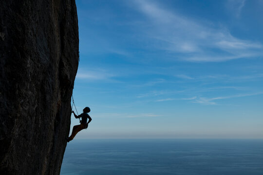 Female rock climber in  Olta mountain, Calpe, Costa Blanca, Alicante Province, Spain