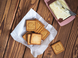 Quick breakfast with cookies and butter on a wooden tray