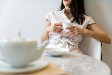 Beautiful Businesswoman Drinking with cup of morning coffee in hands.