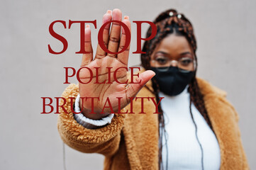 Stop police brutality. African american woman, wear black face mask show stop hand sign.