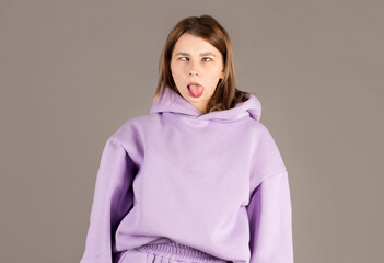 Funny, playful cute woman not scared showing her hilarious side, playing charades, mimicking fish, folding lips and squinting shifting eyes, standing white background upbeat, grimacing