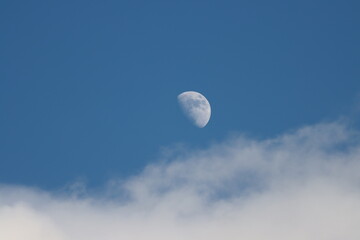 Half moon above clouds