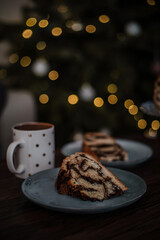 Vertical photo of piece of homemade chocolate wreath in front of a Christmas tree