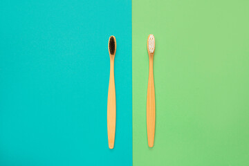 Bamboo toothbrushes on a blue and green background. The concept of environmentally friendly and environmentally friendly toothbrushes. Flat lay. top view. copy space