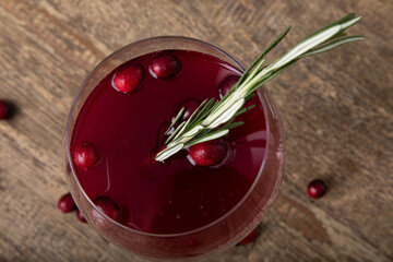 Cranberry juice in wine glass with fresh berries 