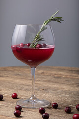 Cranberry juice in wine glass with fresh berries 